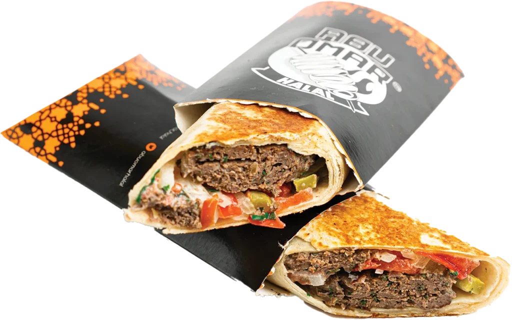 Beef kofta kabob wrap with tomatoes, onions, parsley, mint, pickles and tahini sauce