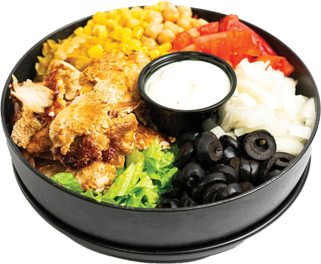 Shaved chicken shawarma over a salad of greens, tomatoes, corn, chickpeas and olives