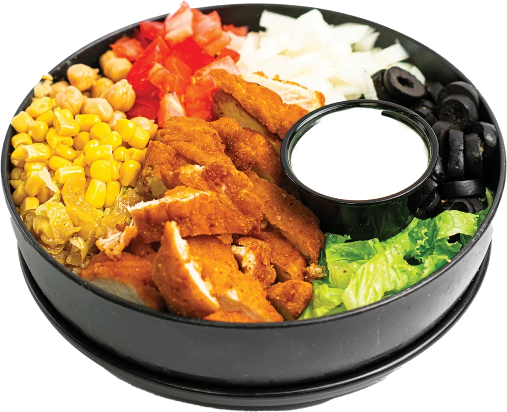Crispy chopped chicken tenders over a salad of tomatoes, onions, corn, chickpeas and olives