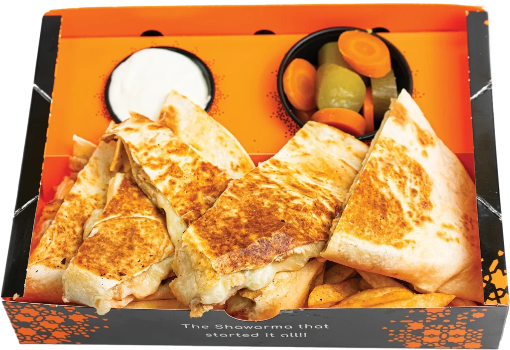 Shawarma quesadilla pressed until crisp and cut into four slices, with seasoned fries